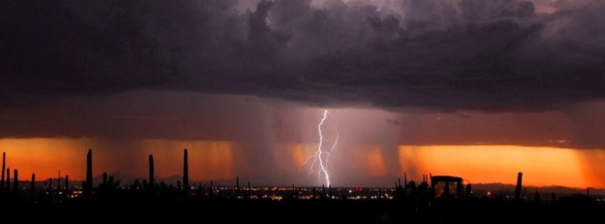Microburst over a city at sunset. 
