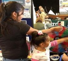 Science fair with children listening to someone who made a project on water