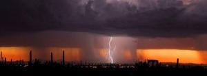 Microburst over a city at sunset. 