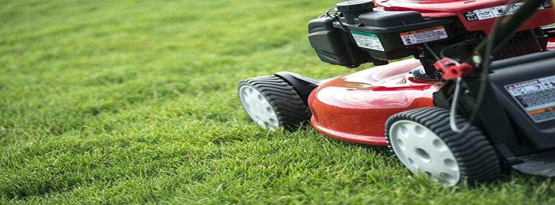 Red lawnmower going over grass